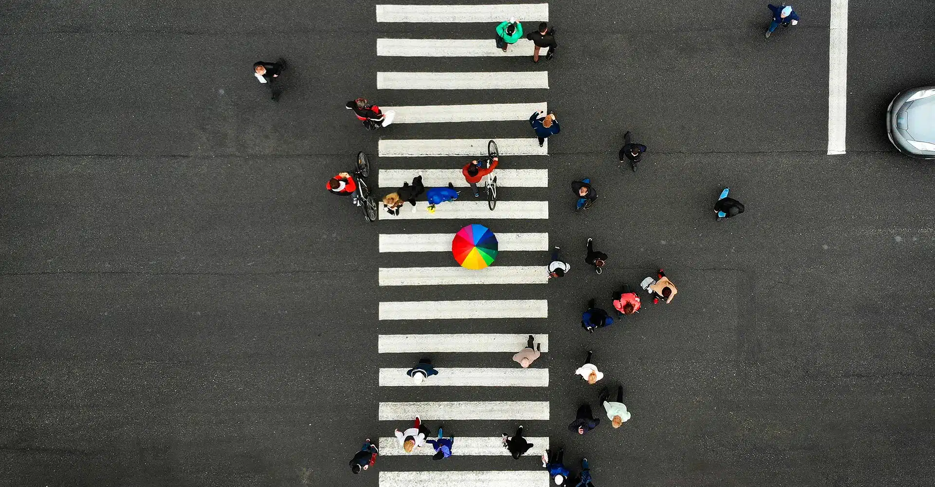 Aerial view of people crossing on zebra crossing in a big city